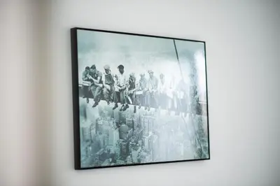 a framed picture of a group of people on a wall at Aida's Apartments in Puentes de García Rodríguez