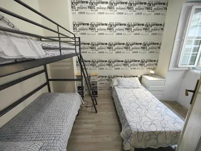 a bedroom with two bunk beds and a wall with a mural at Rua Nova Apartment 28, 3 Dormitorios, WIFI, PS4 y Netflix, a 200m Catedral in Santiago de Compostela