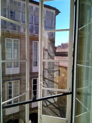 an open window with a view of a building at Rua Nova Apartment 28, 3 Dormitorios, WIFI, PS4 y Netflix, a 200m Catedral in Santiago de Compostela