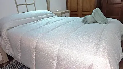 a white bed with two pillows on top of it at Garcia Prieto Vivienda in Santiago de Compostela