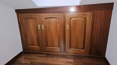 a pair of wooden cabinets in a room at Garcia Prieto Vivienda in Santiago de Compostela