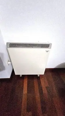 a white radiator sitting on the floor next to a wall at Garcia Prieto Vivienda in Santiago de Compostela