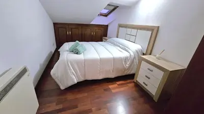 a bedroom with a bed with a blue towel on it at Garcia Prieto Vivienda in Santiago de Compostela