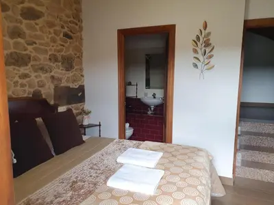a bed with towels and pillows on top of it at la pallota de san cristobal in Palas de Rei