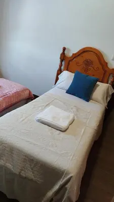 a bed with two towels on top of it at la pallota de san cristobal in Palas de Rei