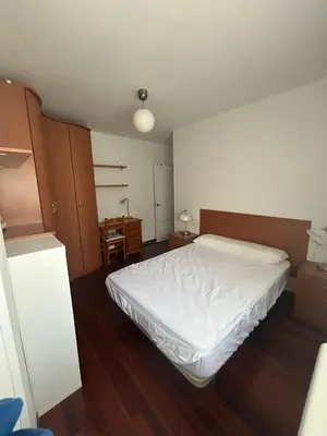 a bedroom with a white bed in a room at la pallota de san cristobal in Palas de Rei