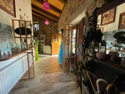 a room with a hallway with wooden floors and a room with a hallway at la pallota de san cristobal in Palas de Rei
