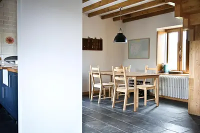 a kitchen and dining room with a table and chairs at Casa Xabú in El Vallin