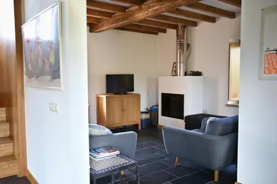 a living room with two chairs and a tv at Casa Xabú in El Vallin
