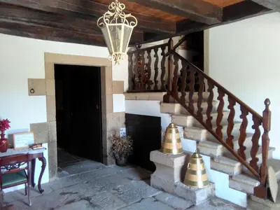 a staircase in a house with a chandelier at Casa Grande de Anllo in Sistallo