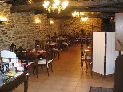 a dining room with tables and chairs in a restaurant at Casa Grande de Anllo in Sistallo