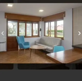 a living room with a couch and chairs and a table at apartamento 1 matrimonial con terraza acristalada in Tapia de Casariego