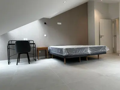 a room with a bed and a chair in it at Apartamento Lujo Casco Histórico in Santiago de Compostela