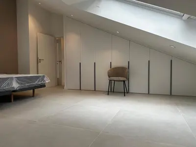 a room with a bed and a chair in it at Apartamento Lujo Casco Histórico in Santiago de Compostela