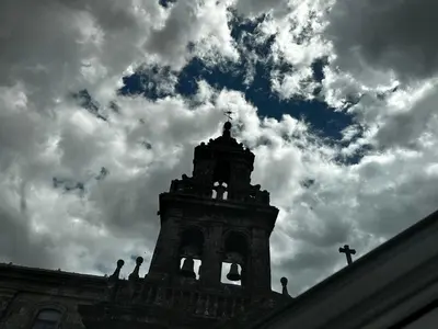 a tower with a cross on top of a building at Apartamento Lujo Casco Histórico in Santiago de Compostela