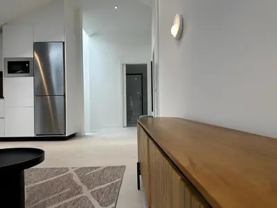 a kitchen with a wooden counter and a refrigerator at Apartamento Lujo Casco Histórico in Santiago de Compostela