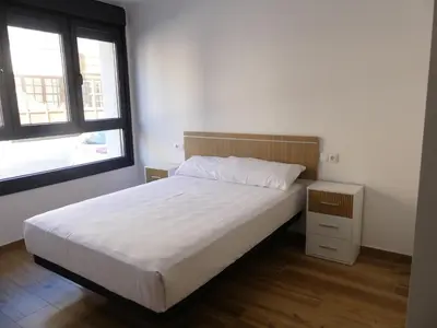 a bedroom with a white bed and a window at Monqar Leandro in Foz