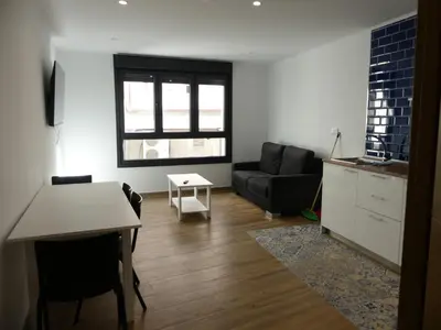 a living room with a couch and a table at Monqar Leandro in Foz