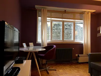 a living room with a table and a window at Apartment Lugo Rooms in Lugo