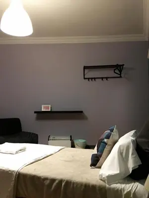 a bedroom with a bed and a shelf on the wall at Apartment Lugo Rooms in Lugo