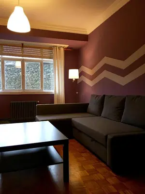 a living room with a couch and a table at Apartment Lugo Rooms in Lugo