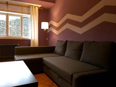 a living room with a couch and a table at Apartment Lugo Rooms in Lugo