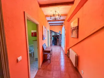 a hallway with orange walls and a table in a room at La Casa del Monte in Ocero