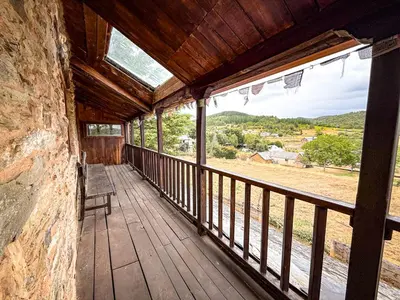 a wooden porch with a view of a field at La Casa del Monte in Ocero