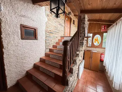 a staircase in a house with a stone wall at La Casa del Monte in Ocero