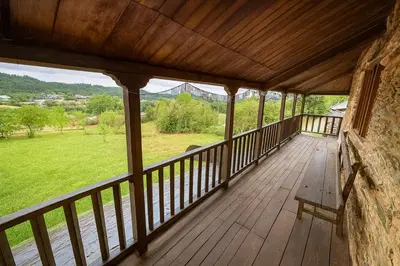 a wooden porch with a view of a green field at La Casa del Monte in Ocero