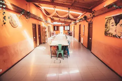a long dining room with a long table and chairs at Albergue Turístico El Campelín in Ocero