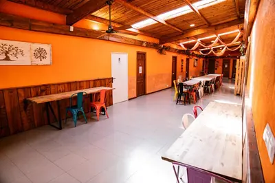 a restaurant with tables and chairs in a room at Albergue Turístico El Campelín in Ocero