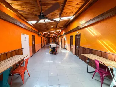 an empty corridor with tables and chairs in a building at Albergue Turístico El Campelín in Ocero