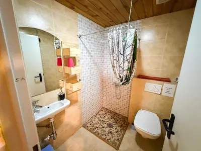 a small bathroom with a toilet and a sink at Albergue Turístico El Campelín in Ocero