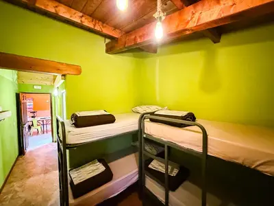 a room with three bunk beds in a room at Albergue Turístico El Campelín in Ocero
