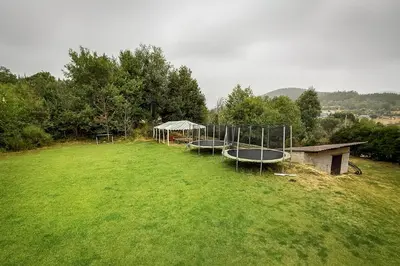 an open field with a group of trays in the grass at Albergue Turístico El Campelín in Ocero