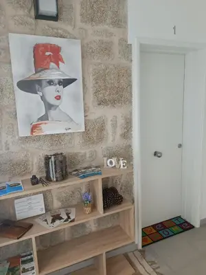 a shelf with a picture of a woman with a hat at Apartamentos Gabín in Montederramo