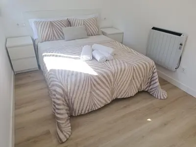a bedroom with a bed with two pillows on it at Apartamentos Gabín in Montederramo