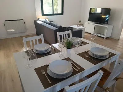a dining room table with plates and wine glasses on it at Apartamentos Gabín in Montederramo