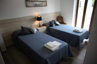 two beds in a room with towels on them at Casa GHOROS in Boente
