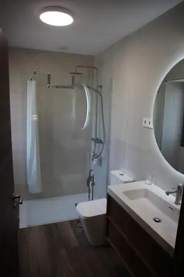 a bathroom with a toilet and a sink and a mirror at Casa GHOROS in Boente