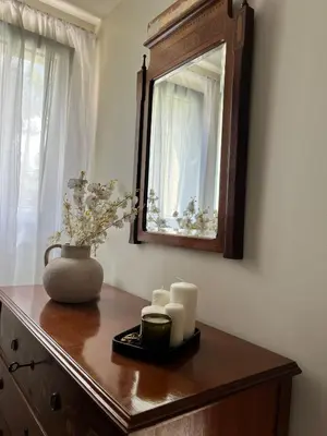 a wooden dresser with a mirror and candles on it at EnGaliciaEs - Casa alquiler turistico en ingles!