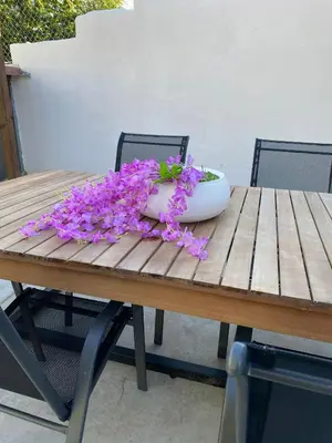 a bowl of purple flowers sitting on a wooden table at EnGaliciaEs - Casa alquiler turistico en ingles!