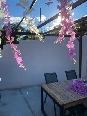 a wooden table with flowers hanging from a ceiling at EnGaliciaEs - Casa alquiler turistico en ingles!