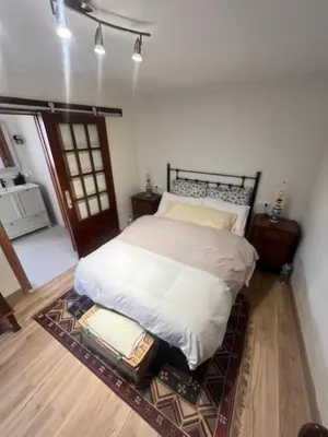 a bedroom with a large bed with a rug at EnGaliciaEs - Casa alquiler turistico en ingles!