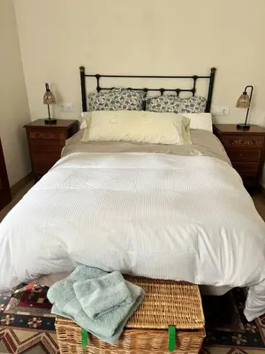 a bedroom with a large bed with towels on it at EnGaliciaEs - Casa alquiler turistico en ingles!