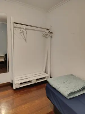 a room with a bed and a closet with a mirror at Kilómetro99 in Lugo