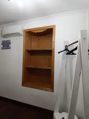 a wooden cabinet in a room with a wall at Kilómetro99 in Lugo