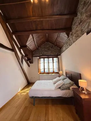 a bedroom with a large bed in a attic at Casa Chita in Tapia de Casariego