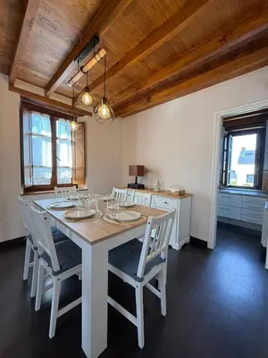 a dining room with a white table and chairs at Casa Chita in Tapia de Casariego